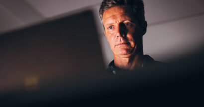 Dr Ian Norton sitting at laptop