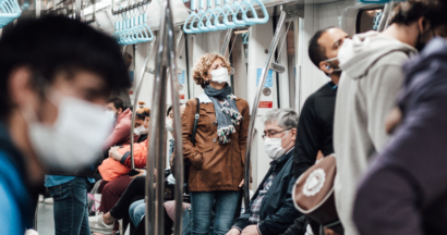 People masked on a busy metro