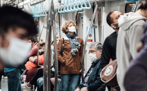 People masked on a busy metro