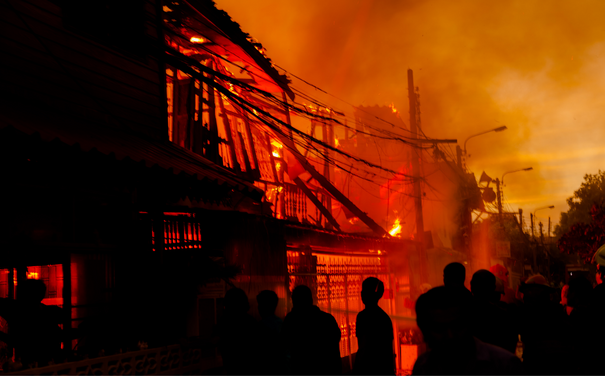Building on fire with people in the street